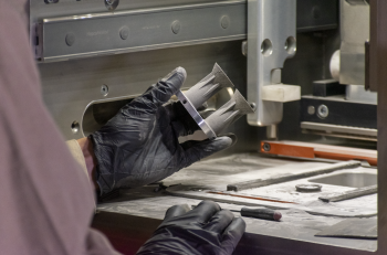 Additive manufacturing with 7A77.60L aluminum alloy: An HRL scientist completes visual inspection of 3D-printed micro-thrusters after build completion .