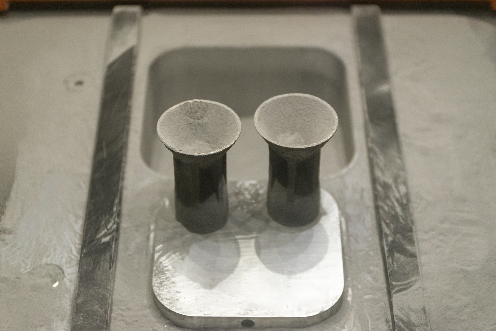 Additive manufacturing with 7A77.60L aluminum alloy: Micro-thrusters prior to full powder removal.
