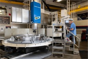 Figure 4. An Orion forward bulkhead made out of titanium being machined on the new large diameter vertical turret lathe.