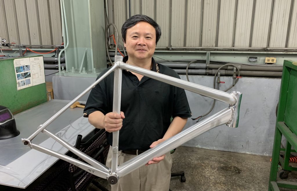 Figure 1. Prof. Xiaochun Li, founder and chief scientist of MetaLi, holding a prototype bike frame welded together with the company’s proprietary AA7075 welding wire. 