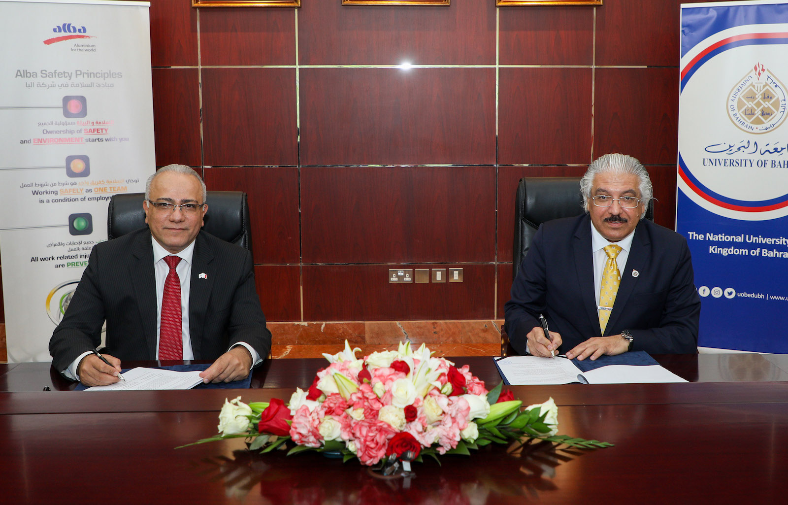 Ali Al Baqali, CEO of Alba (left), and Prof. Riyad Yousif Hamzah, president of the University of Bahrain (right), sign an MOU at the Alba premises. aluminum research