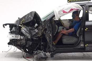 Figure 1. A Honda Pilot following the small overlap front crash test on the driver side. The position of the dummy shows that the driver compartment remained intact. (Source: IIHS.)