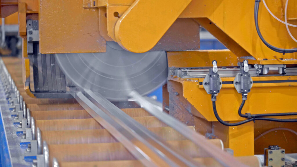 Figure 2. The automated flying hot saw cuts the profiles as they exit the press.