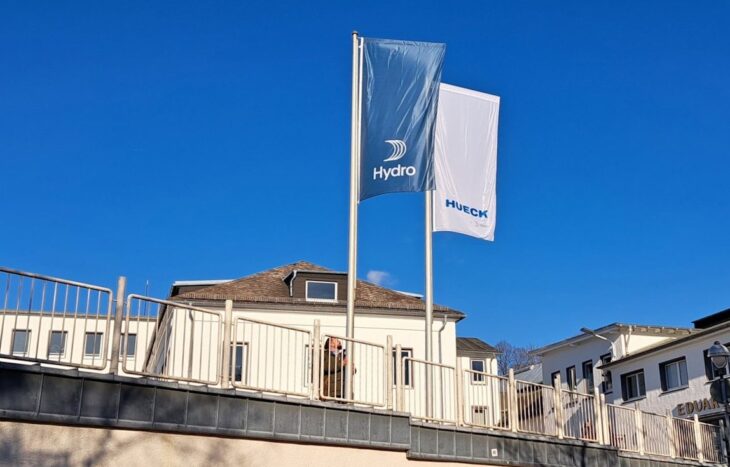 Image of a building with blue and white flags that read Hydro and Hueck