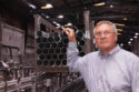 Steve James, managing director at Alfiniti, stands in front of 6061-T8 tubes.