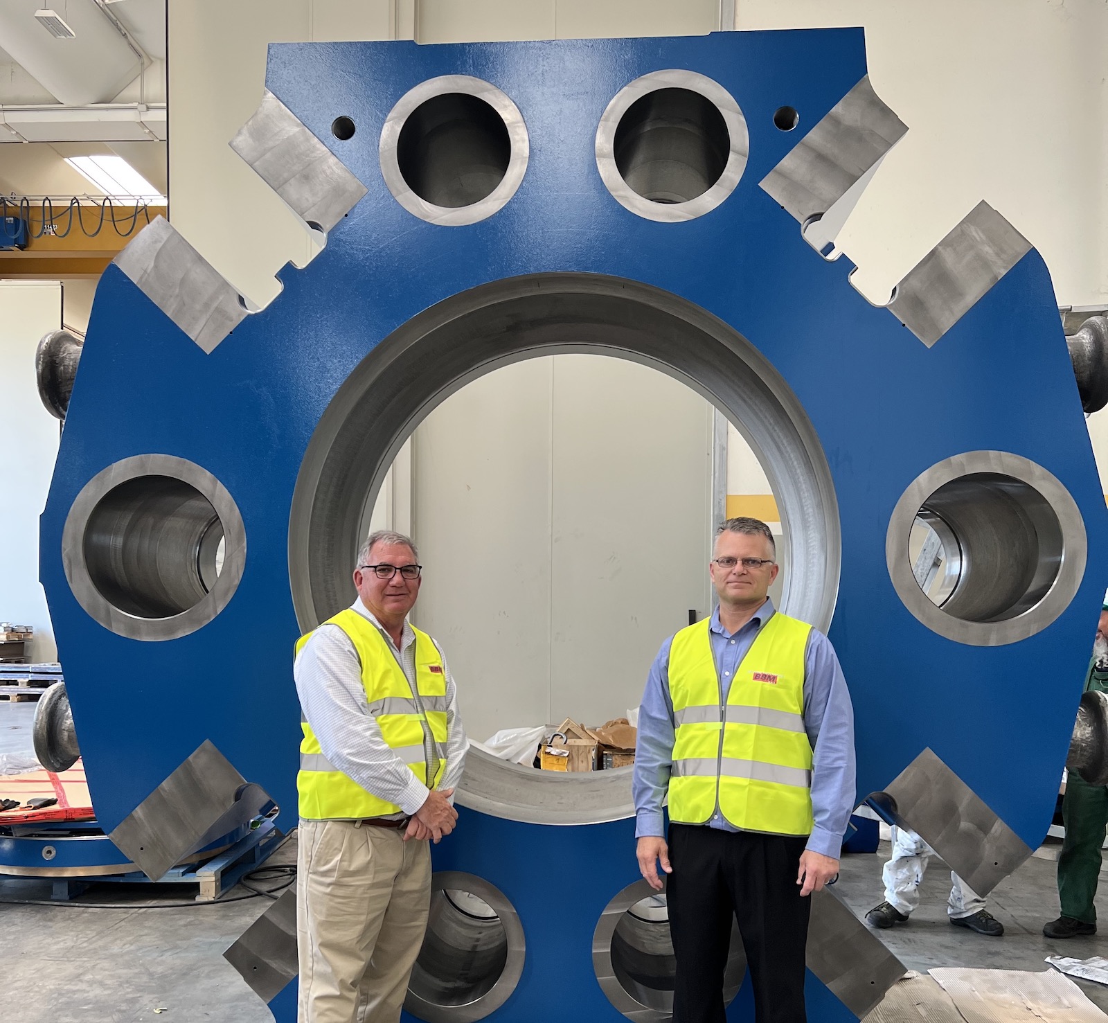 Figure 1. L-R: Nick Kohn, owner of Belco Industries, and Charlie Hall, president of EAC, visit the new press while under construction at OMAV’s plant in Italy.