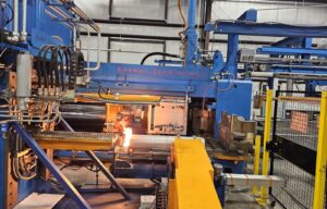 Figure 3. A heated billet being loaded into the press.