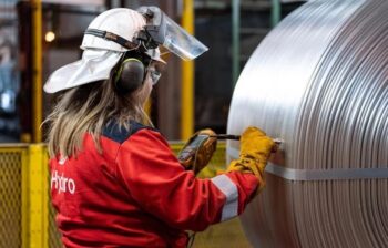 an operator scans a coil of aluminum wire rod