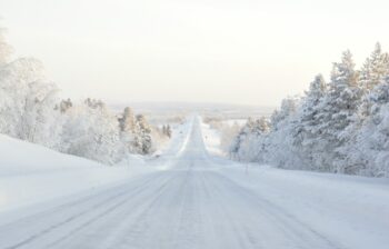 A road leading out into a snowy landscape in Finland