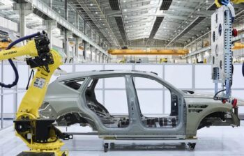 An aluminum spaceframe on a vehicle assembly line.