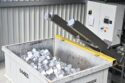 Briquetted aluminum chips in a bin
