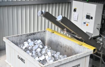 Briquetted aluminum chips in a bin