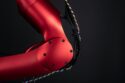 a close up of a red bike with a black background
