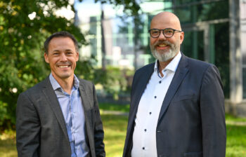 Two men stand side by side