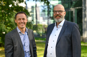 Two men stand side by side