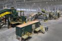 Two men appear tiny in an arial view of this scrap sorting equipment.