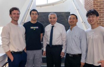Five men standing on the stairs