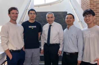 Five men standing on the stairs