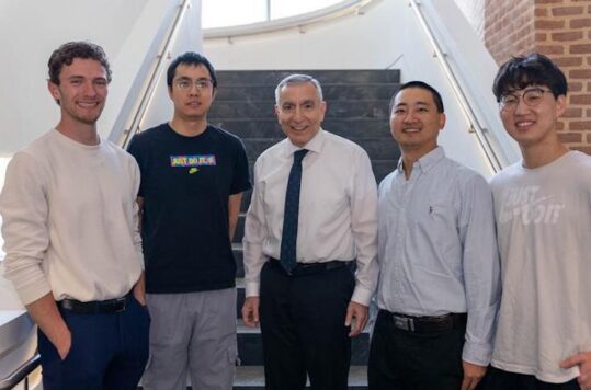 Five men standing on the stairs