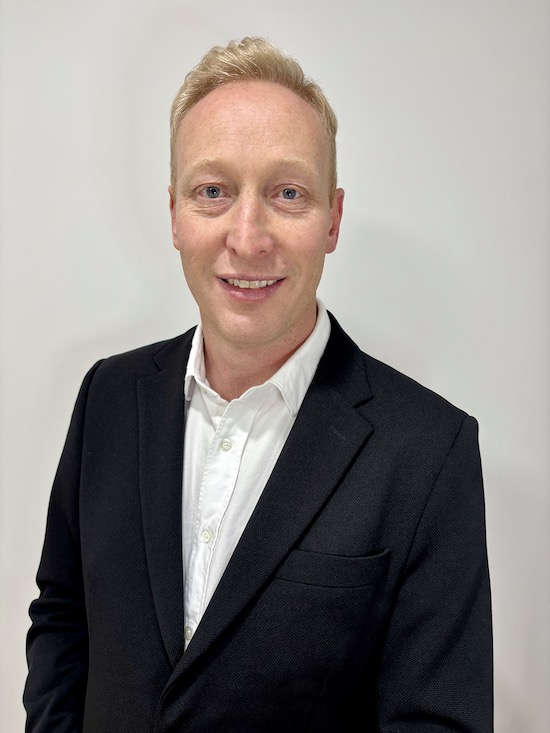Headshot of a man in a black suite