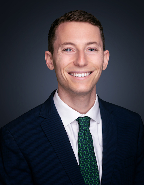 Headshot of a young man in a suit