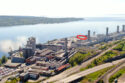 Aerial view of an industrial plant. A red circle indicates the placement of a new recycling area.