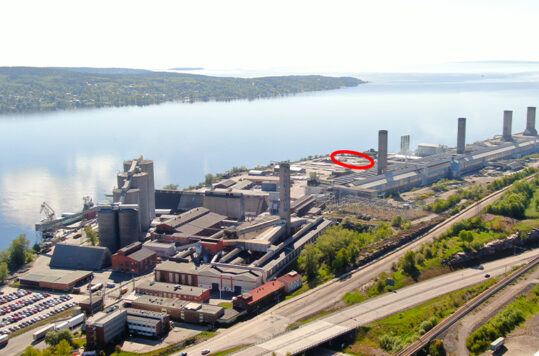 Aerial view of an industrial plant. A red circle indicates the placement of a new recycling area.