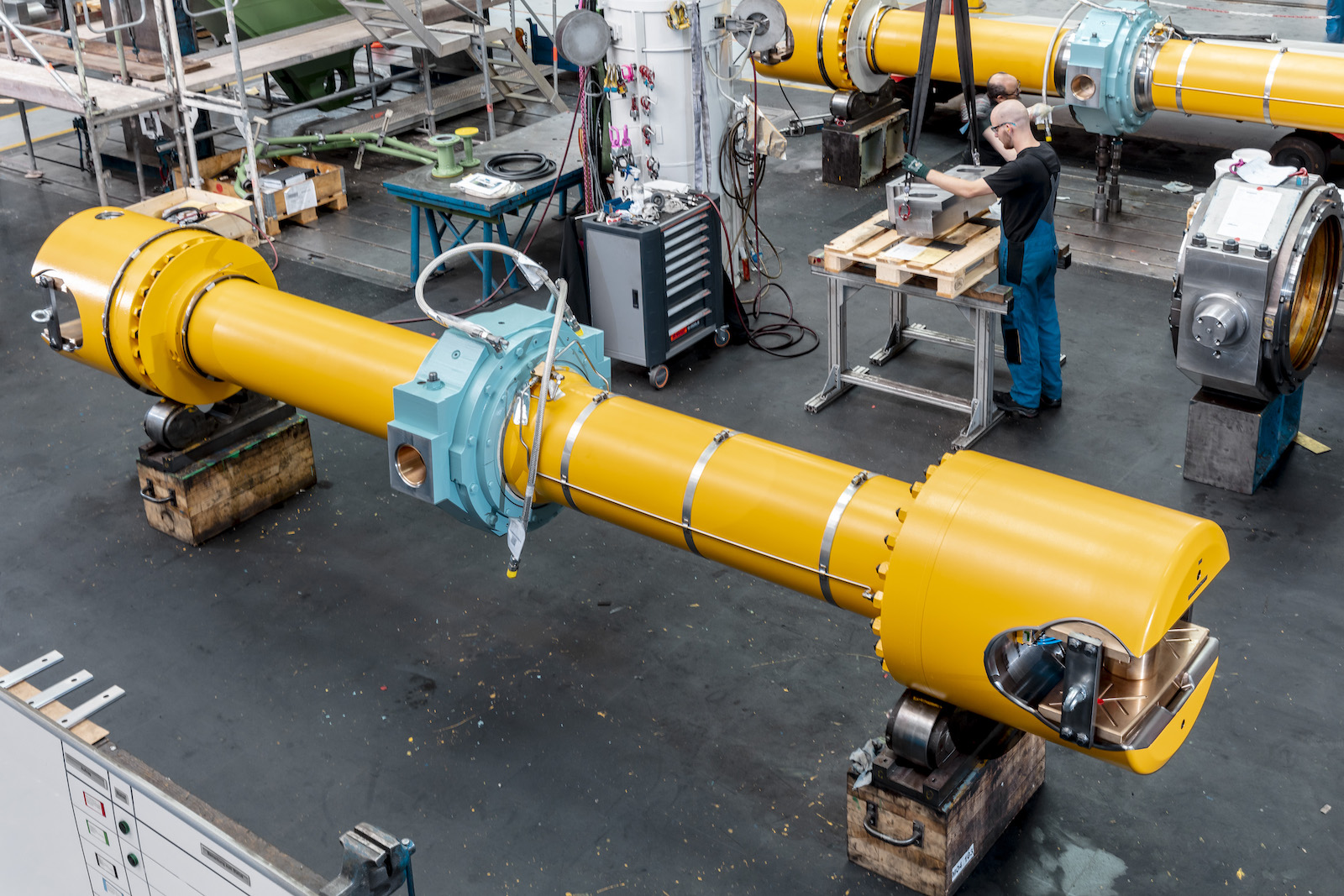 A giant industrial spindle. The man standing nearby looks small in comparison.