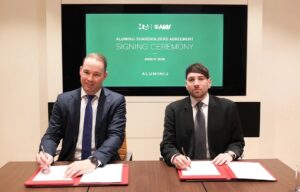 Two men in suits at a signing ceremony