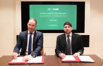 Two men in suits at a signing ceremony