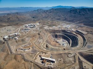 Aerial view of a rare earth elements open-pit mine, surrounded by desert.