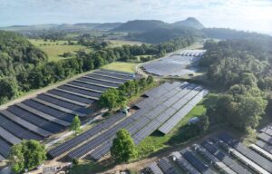 Aerial view of a solarpark in green fields.